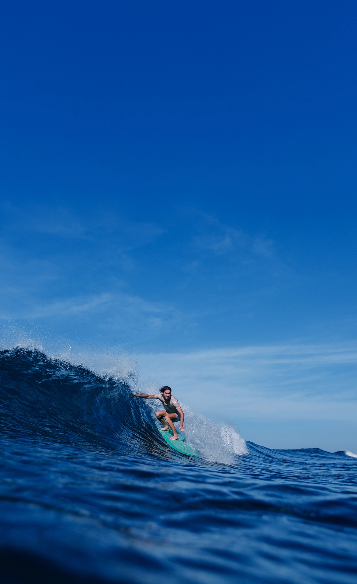 Surfista em uma onda azul